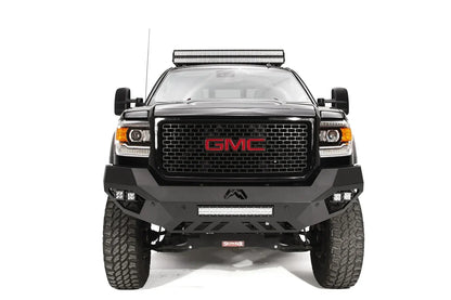 Fab Fours Vengeance front bumper on a black GMC Sierra 2500HD, straight-on front view, showing the sculpted no-guard face, center LED light bar and outboard cube lights