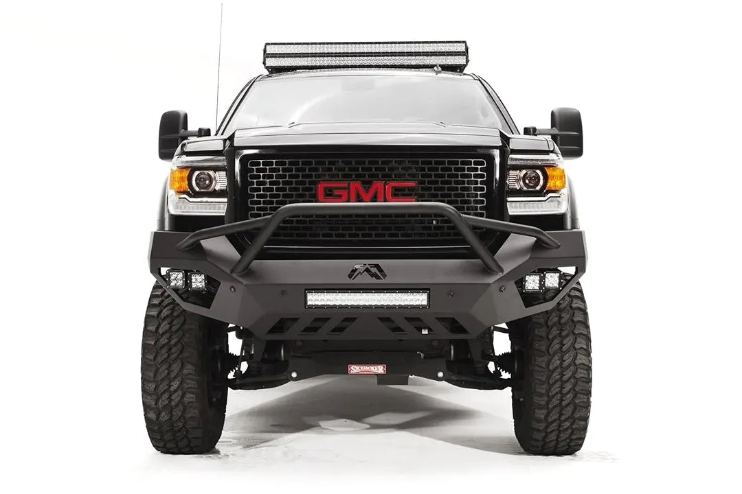 Fab Fours Vengeance front bumper with pre-runner guard on a black GMC Sierra 2500HD, straight-on front view, showing the pre-runner hoop, center LED light bar and outboard cube lights