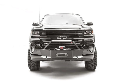 Fab Fours winch mount on a black and gray Chevrolet Silverado 1500, straight-on front view, showing tubular hoop, winch plate, low-profile mounting under the factory bumper