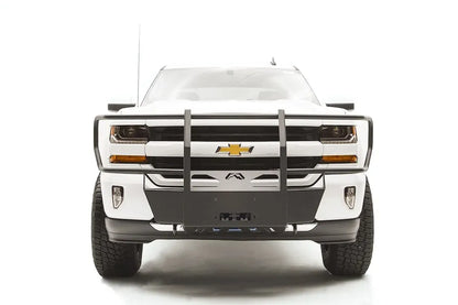 Fab Fours winch mount with full guard on a white Chevrolet Silverado 1500, straight-on front view, showing full grille guard uprights, winch plate, wraparound headlight hoops