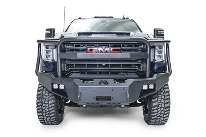 Fab Fours Premium Winch front bumper with full guard on a blue and gray GMC Sierra 2500HD/3500HD, straight-on front view, showing full guard hoop, winch mount opening, cube light pods, angled end caps