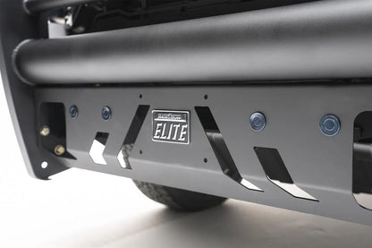 Fab Fours Black Steel Elite front bumper with full guard on a blue GMC Sierra 2500HD/3500HD, close-up of the front corner, showing full guard side hoop, bumper end profile, wheel-well clearance