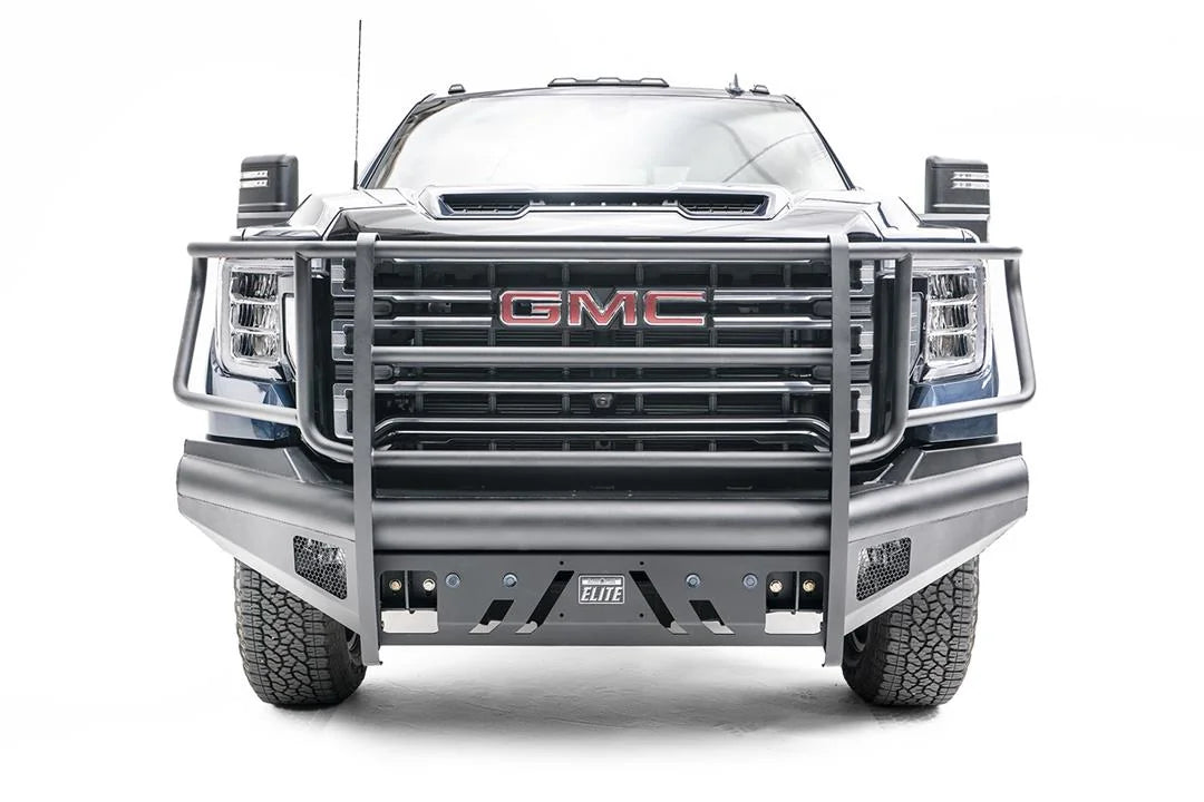 Fab Fours Black Steel Elite front bumper with full guard on a blue GMC Sierra 2500HD/3500HD, straight-on front view, showing full grille guard, Elite badge, slotted skid plate, mesh end inserts