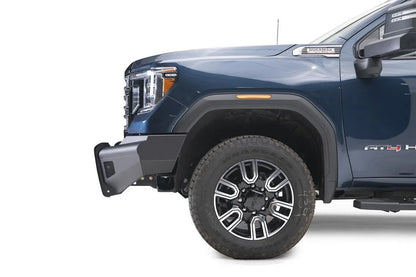Fab Fours Black Steel Elite front bumper on a blue GMC Sierra 2500HD/3500HD, close-up of the front corner, showing bumper end profile, mesh insert, wheel-well clearance