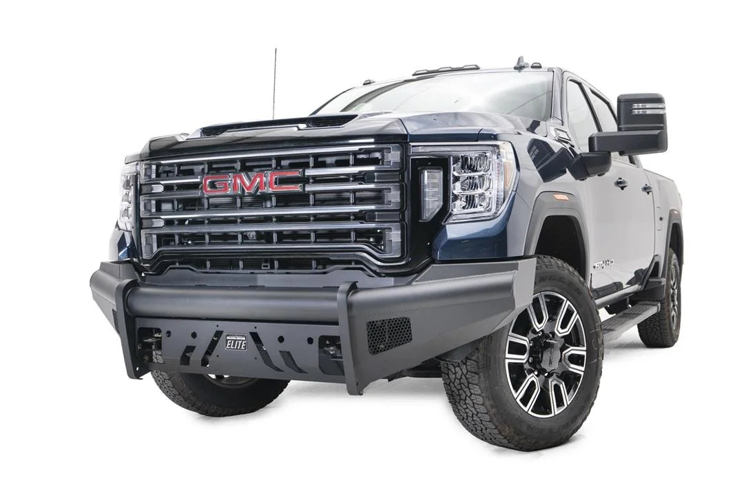Fab Fours Black Steel Elite front bumper on a blue GMC Sierra 2500HD/3500HD, front driver-side three-quarter view, showing Elite badge, slotted skid plate, mesh end inserts, top tube