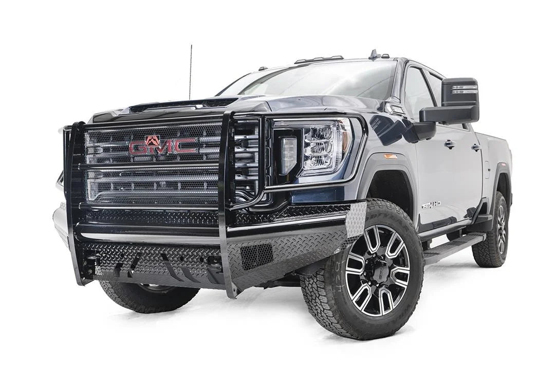 Fab Fours Black Steel front bumper with full guard on a blue GMC Sierra 2500HD/3500HD, front driver-side three-quarter view, showing full grille guard, diamond-plate finish, mesh end inserts