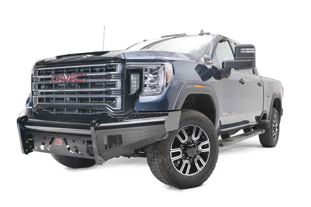 Fab Fours Black Steel front bumper on a blue GMC Sierra 2500HD/3500HD, front driver-side three-quarter view, showing diamond-plate finish, top tube, mesh end inserts, Fab Fours badge