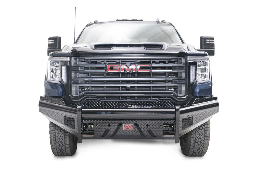 Fab Fours Black Steel front bumper on a blue GMC Sierra 2500HD/3500HD, straight-on front view, showing diamond-plate finish, top tube, mesh end inserts, Fab Fours badge