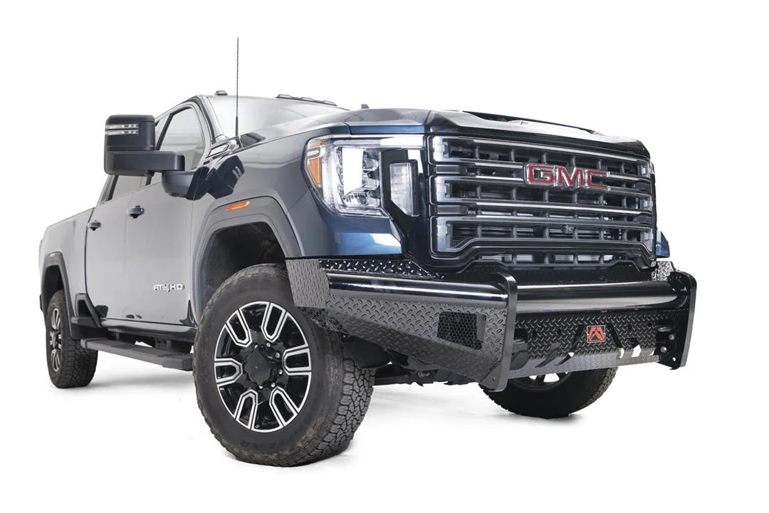 Fab Fours Black Steel front bumper on a blue GMC Sierra 2500HD/3500HD, front passenger-side three-quarter view, showing diamond-plate finish, top tube, mesh end inserts, Fab Fours badge