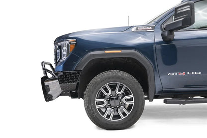 Fab Fours Black Steel front bumper with pre-runner guard on a blue GMC Sierra 2500HD/3500HD, close-up of the front corner, showing pre-runner hoop, diamond-plate end, wheel-well clearance