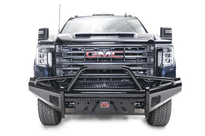 Fab Fours Black Steel front bumper with pre-runner guard on a blue GMC Sierra 2500HD/3500HD, straight-on front view, showing pre-runner hoop, diamond-plate finish, mesh end inserts, Fab Fours badge