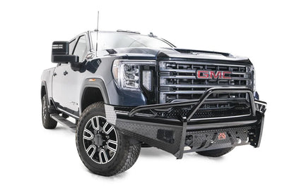 Fab Fours Black Steel front bumper with pre-runner guard on a blue GMC Sierra 2500HD/3500HD, front passenger-side three-quarter view, showing pre-runner hoop, diamond-plate finish, mesh end inserts, Fab Fours badge
