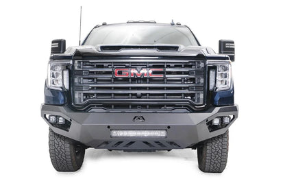 Fab Fours Vengeance front bumper on a blue GMC Sierra 2500HD/3500HD, straight-on front view, showing integrated light bar, cube light pods, angular skid plate