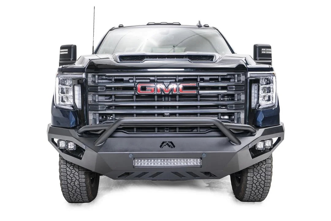 Fab Fours Vengeance front bumper with pre-runner guard on a blue GMC Sierra 2500HD/3500HD, straight-on front view, showing pre-runner hoop, integrated light bar, cube light pods, angular skid plate