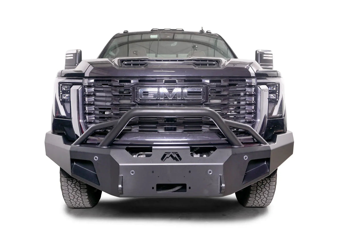 Fab Fours Premium Winch front bumper with pre-runner guard on a black GMC Sierra 2500HD/3500HD, straight-on front view, showing pre-runner hoop, winch mount opening, angled end caps