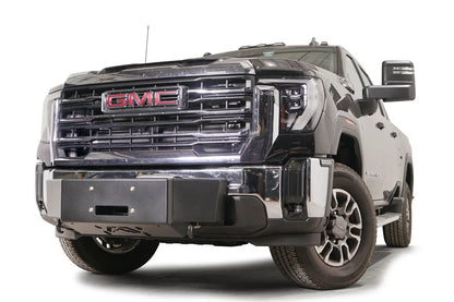 Fab Fours winch mount on a black GMC Sierra 2500HD/3500HD, front driver-side three-quarter view, showing winch plate, factory bumper integration, center mounting