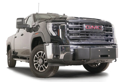 Fab Fours winch mount on a black GMC Sierra 2500HD/3500HD, front passenger-side three-quarter view, showing winch plate, factory bumper integration, center mounting