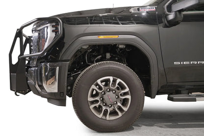 Fab Fours winch mount with full guard on a black GMC Sierra 2500HD/3500HD, close-up of the front corner, showing full guard side hoop, winch mount profile, wheel-well clearance