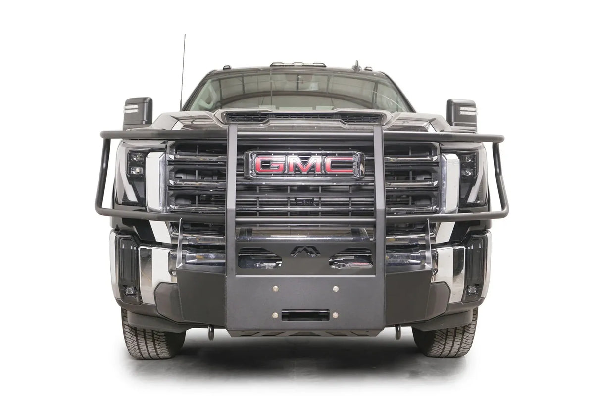 Fab Fours winch mount with full guard on a black GMC Sierra 2500HD/3500HD, straight-on front view, showing full guard uprights, wraparound headlight hoops, winch plate