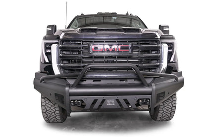 Fab Fours Black Steel Elite front bumper with pre-runner guard on a black GMC Sierra 2500HD/3500HD, straight-on front view, showing pre-runner hoop, Elite badge, slotted skid plate, mesh end inserts