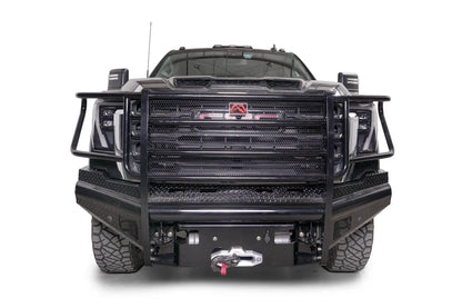 Fab Fours Black Steel front bumper with full guard on a black GMC Sierra 2500HD/3500HD, straight-on front view, showing full grille guard, diamond-plate finish, mesh end inserts, winch