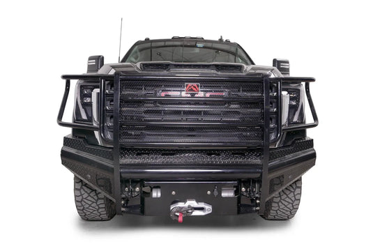 Fab Fours Black Steel front bumper with full guard on a black GMC Sierra 2500HD/3500HD, straight-on front view, showing full grille guard, diamond-plate finish, mesh end inserts, winch