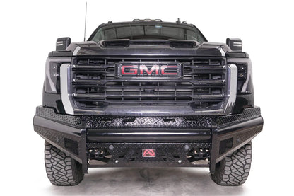 Fab Fours Black Steel front bumper on a black GMC Sierra 2500HD/3500HD, straight-on front view, showing diamond-plate finish, top tube, mesh end inserts, Fab Fours badge
