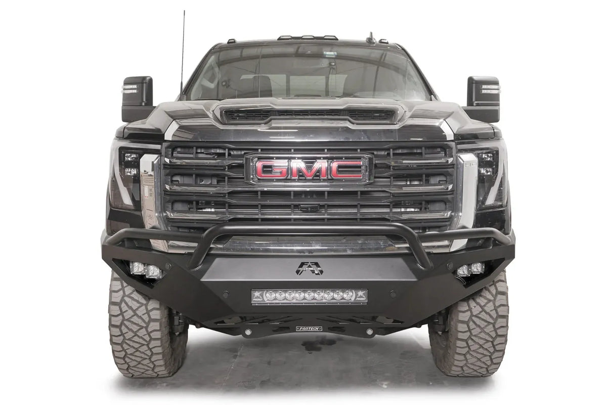 Fab Fours Vengeance front bumper with pre-runner guard on a black GMC Sierra 2500HD/3500HD, straight-on front view, showing pre-runner hoop, integrated light bar, cube light pods