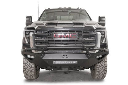 Fab Fours Vengeance front bumper with pre-runner guard on a black GMC Sierra 2500HD/3500HD, straight-on front view, showing pre-runner hoop, integrated light bar, cube light pods