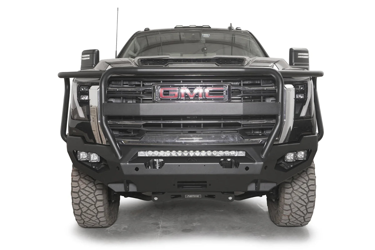Fab Fours Matrix front bumper with full guard on a dark gray GMC Sierra 2500HD/3500HD, straight-on front view, showing full guard hoop, integrated light bar, cube light pods