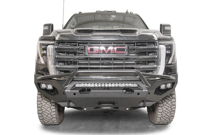 Fab Fours Matrix front bumper with pre-runner guard on a black GMC Sierra 2500HD/3500HD, straight-on front view, showing pre-runner hoop, integrated light bar, cube light pods
