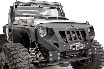 Fab Fours Grumper front bumper in Stubby configuration on a gray Jeep Wrangler JK, close-up of the front corner, showing grille-integrated design, winch and fairlead, bolted plate construction