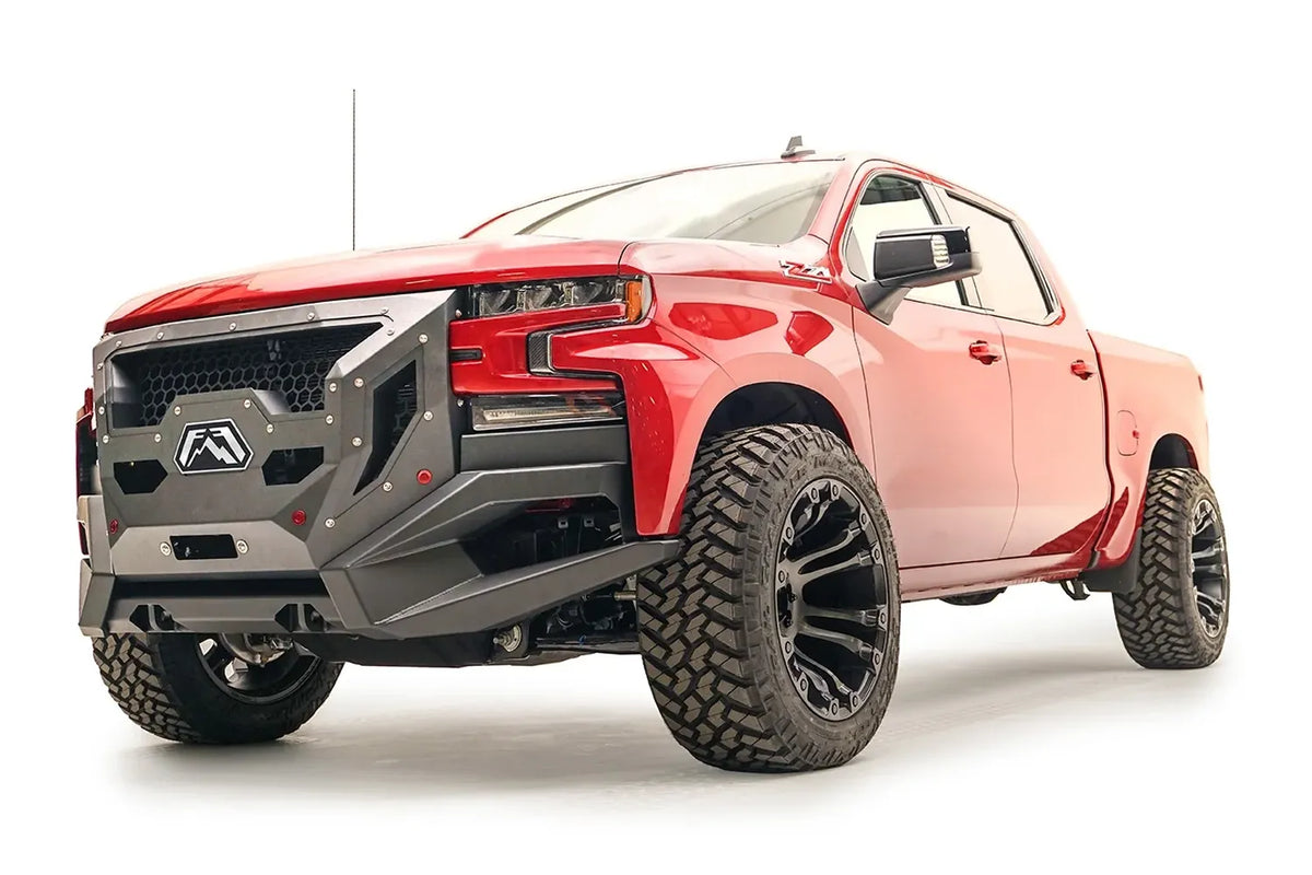 Fab Fours Grumper front winch bumper with full guard on a lifted red 2019–2021 Chevrolet Silverado 1500, front driver-side view, showing the full grille guard with honeycomb mesh and the angular bumper wings clearing the front tires