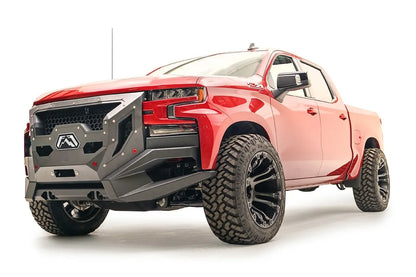 Fab Fours Grumper front winch bumper with full guard on a lifted red 2019–2021 Chevrolet Silverado 1500, front driver-side view, showing the full grille guard with honeycomb mesh and the angular bumper wings clearing the front tires