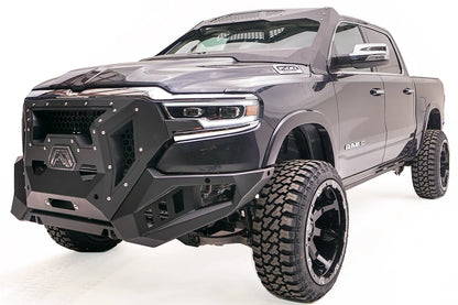 Fab Fours Grumper front winch bumper with honeycomb mesh grille on a lifted dark gray Ram 1500, driver-side front three-quarter view