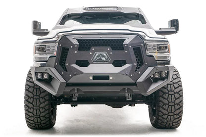 Fab Fours Grumper crash bar on a lifted white Ram 2500, front view, with honeycomb mesh grille panels, Fab Fours logo plate, and dual cube lights in each bumper corner