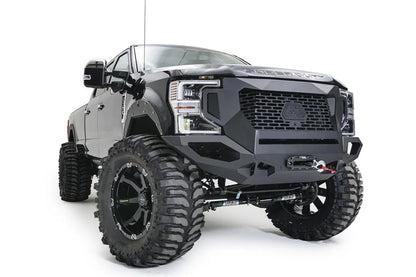 Fab Fours Grumper front winch bumper on a lifted black Ford F-250 Super Duty, passenger-side front three-quarter view, with Warn winch and Fab Fours fender flares