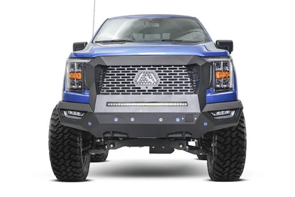 Fab Fours Grumper front bumper and grille on a lifted blue Ford F-150, front view, with mesh grille, Fab Fours logo plate, and LED light bar