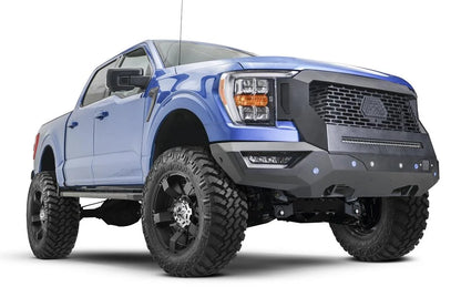Fab Fours Grumper front bumper and grille with mesh grille and LED light bar on a lifted blue Ford F-150, passenger-side front three-quarter view