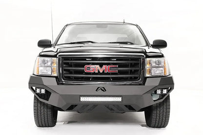 Fab Fours Vengeance front bumper on a black and gray GMC Sierra 1500, straight-on front view, showing integrated light bar, cube light pods, angular skid plate