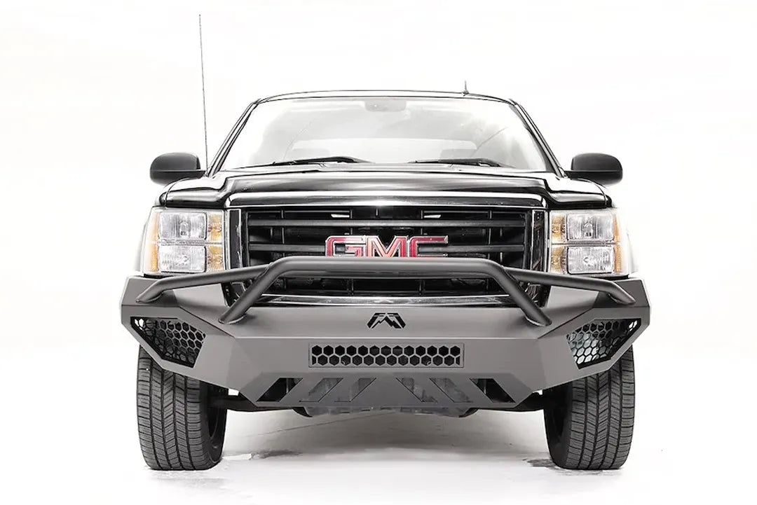 Fab Fours Vengeance front bumper with pre-runner guard on a black and gray GMC Sierra 1500, straight-on front view, showing pre-runner hoop, honeycomb mesh inserts, angular skid plate
