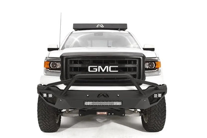 Fab Fours Vengeance front bumper with pre-runner guard on a white GMC Sierra 1500, straight-on front view, showing pre-runner hoop, integrated light bar, cube light pods