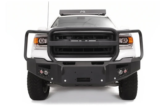Fab Fours Premium heavy duty winch front bumper with full grille guard on a white GMC Sierra 1500