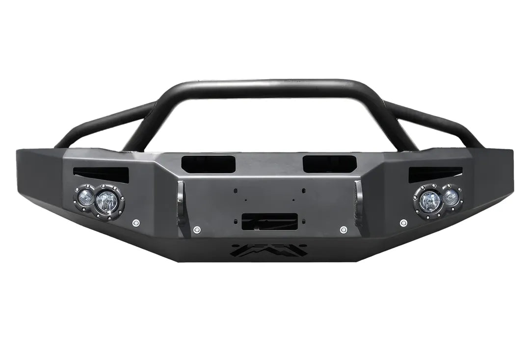 Fab Fours Premium Heavy Duty Winch front bumper with pre-runner guard in black powder coat, straight-on front view, showing pre-runner hoop, winch plate, round fog light pods