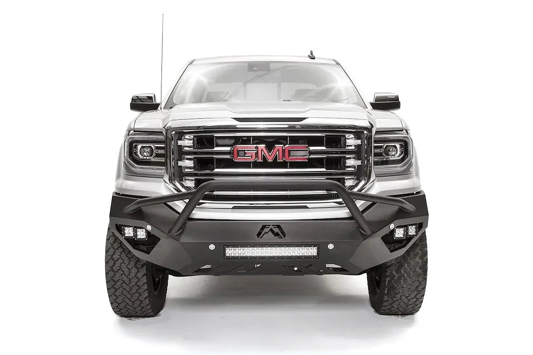 Fab Fours Vengeance front bumper with pre-runner guard on a white GMC Sierra 1500, straight-on front view, showing the pre-runner hoop, corner pod lights and center light bar