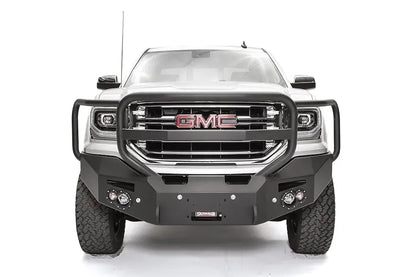 Fab Fours Premium Winch front bumper with full guard on a white GMC Sierra 1500, straight-on front view, showing the full grille guard with headlight hoops, winch fairlead opening and round fog lights