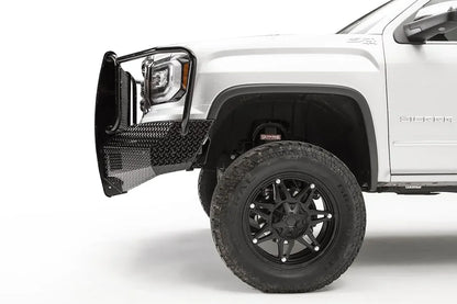 Fab Fours Black Steel front bumper with full guard on a white GMC Sierra 1500, close-up of the front corner, showing the full guard upright, diamond-plate end cap and wheel clearance