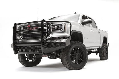 Fab Fours Black Steel front bumper with full guard on a white GMC Sierra 1500, driver-side front three-quarter view, showing the full grille guard, diamond-plate bumper face and wrapped end caps