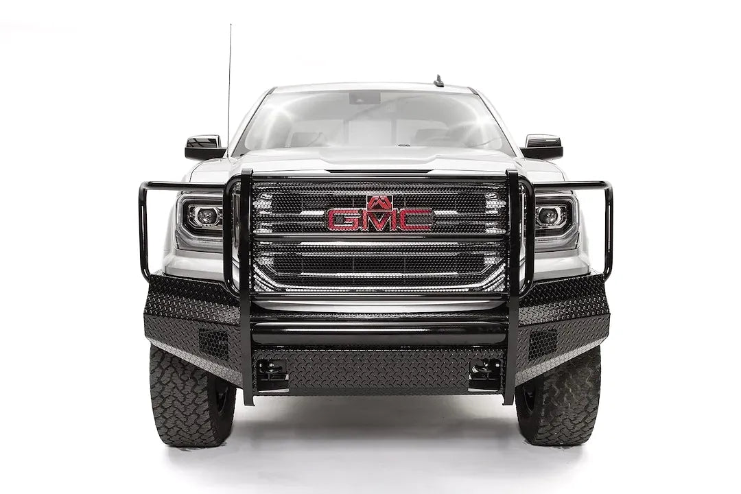 Fab Fours Black Steel front bumper with full guard on a white GMC Sierra 1500, straight-on front view, showing the full grille guard with headlight hoops and diamond-plate bumper face