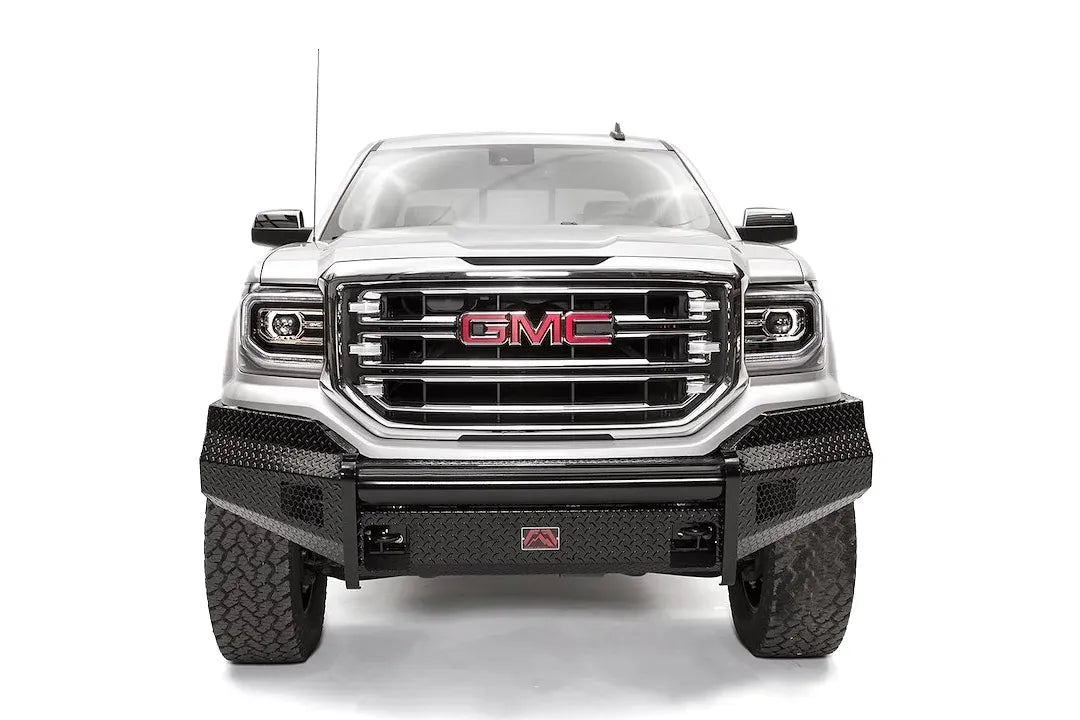 Fab Fours Black Steel front bumper on a white GMC Sierra 1500, straight-on front view, showing the diamond-plate bumper face, wrapped end caps and center shackle mount